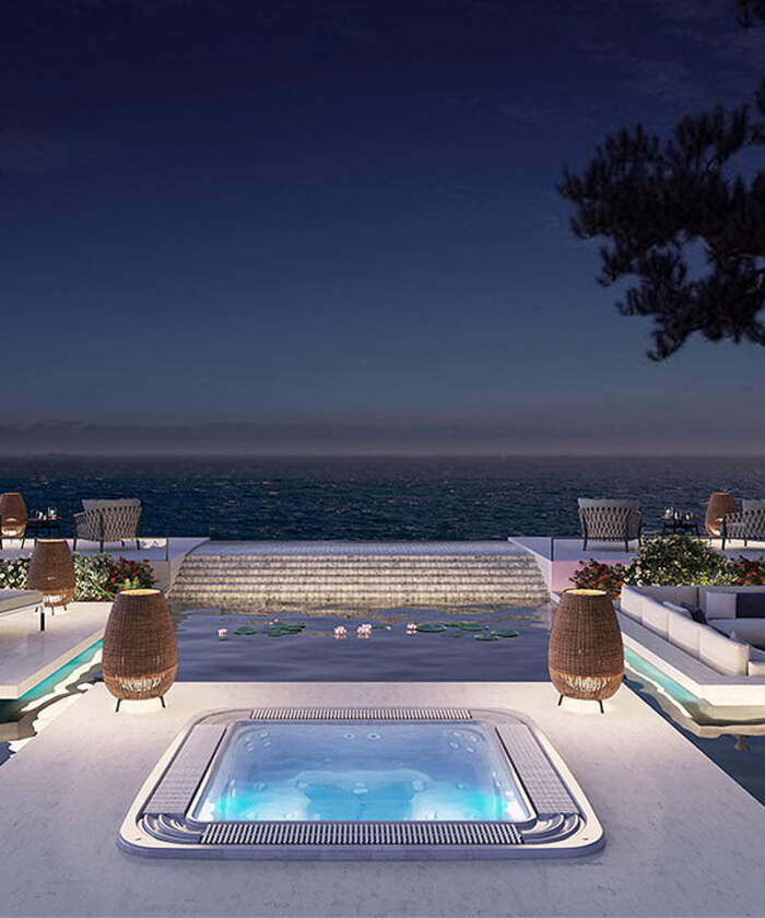 Astralpool Verona overflow spa with nighttime hotel view