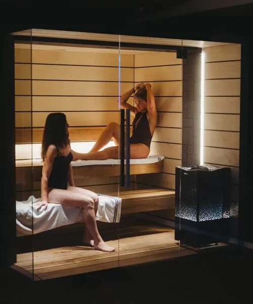 2 women enjoying a session in the Tylo Reflection Sauna GC WIDE